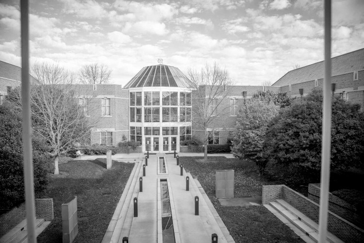 The small reflection pools lead up to the Math and Science building in evening summer light.